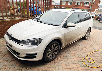 A Dirty VW Passet before a mobile valeting service in Stoke-on-Trent - front view